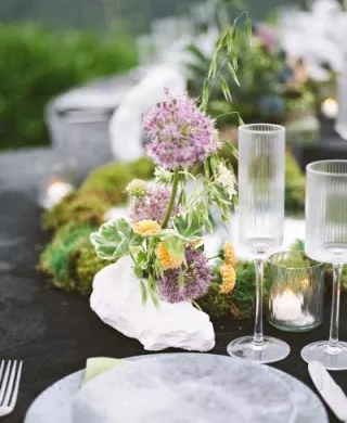 Place setting on moody detail-oriented tablescape and Grand View Malibu 