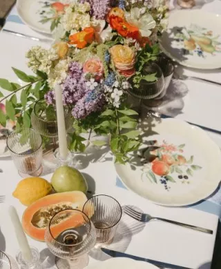 Minimal beach tablescape with bright florals and fruit accents at Pelican Brewing