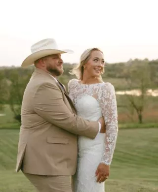 Monica and Matt pose in their wedding attire at their private residence 