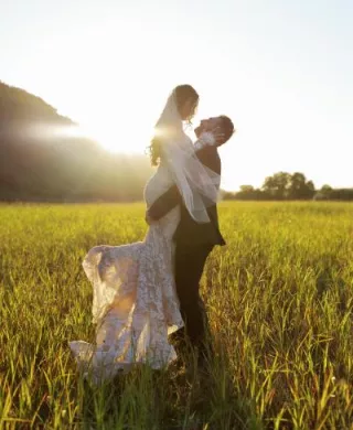 Morgan and Anthony pose in the mustard field of Tar Creek Ranch on their wedding day
