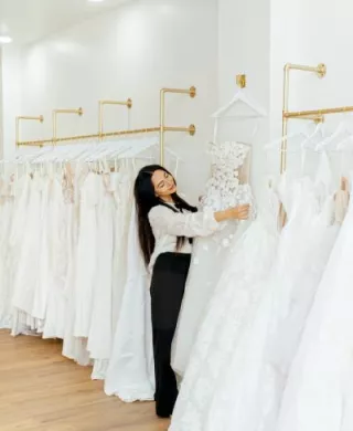 Owner of Mareh Couture Bridal with the dresses on display