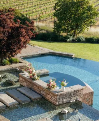 Pink florals in vases decorate the poolside reception at Mira Vista Estate