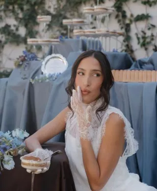 Model poses, wiping her mouth after eating a sweet treat