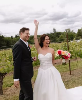 Amanda and Sam cheer on their wedding day at Oswego Hills Winery