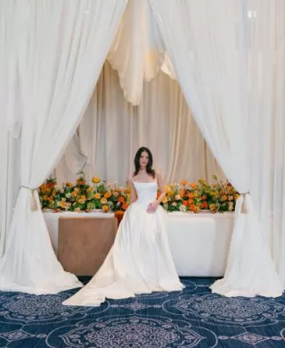 Model poses in front of boldly styled reception table at The Sentinel