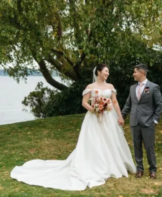 Jane and Abner pose in their wedding attire on the grounds of The Woodmark Hotel & Still Spa