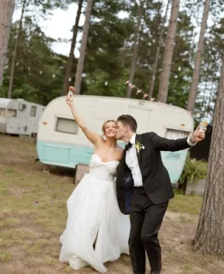 Molly and Ralph pose with their ice cream cones on their wedding day at Camp Elsewhere