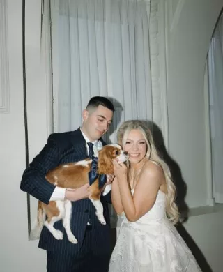 Keland + Dillon posing with their beloved king charles dog