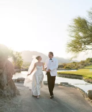 Emily and Vladimir cross the grounds of The Reserve Club during golden hour on their wedding day