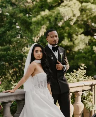 Jenny and Joseph pose side by side in their wedding attire at Villa Terrace