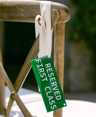 Aviation themed escort card hanging on chair