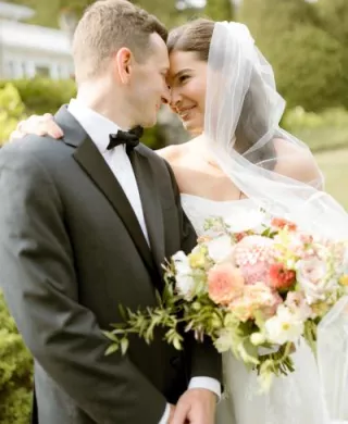 Tom and Clare embrace on their wedding day at Alpine REsort
