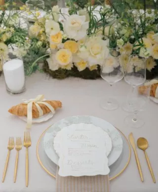 Butter yellow tablescape featuring lush florals and croissant details at Zenia