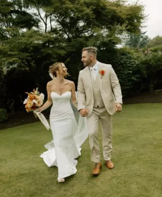 Sarah and Josh walk the grounds of the bride's childhood home on their lakeside wedding day
