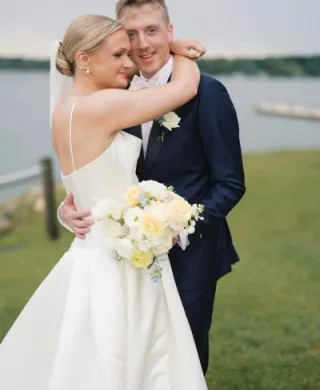 Grace and Lucas embrace with the lake in the background