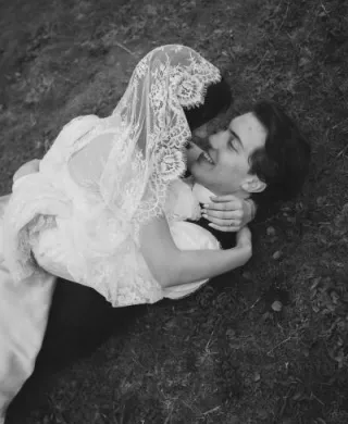 Mykayla and Jake roll in the beach grass during their elopment