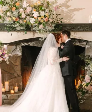 Lilly and Michael share a kiss on their wedding day at Chateau Lil