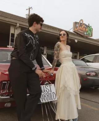 Bride and Groom pose outside of their restaurant wedding day 
