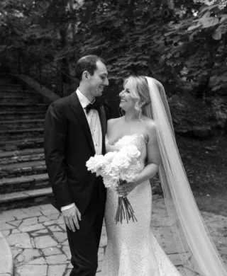 Bride and groom share a loving glance on the grounds outside of Livestock Exchange Ballrooms in Omaha
