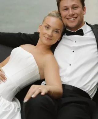 Bride leans on the shoulder of her groom, lounging on their wedding day at The Joslyn