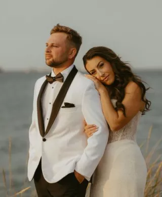 Laney rests her head on Troy's shoulder in their wedding attire 