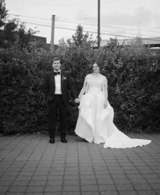 Allie and Max pose side by side on their wedding day