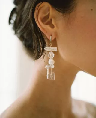 Close-up of a handcrafted glass earring from Rileyhaus featuring a delicate, artisanal design