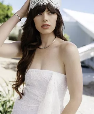 Model poses in strapless lace dress and trendy head wrap