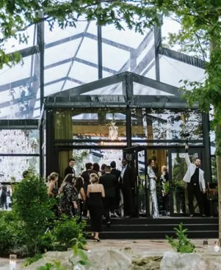 Guests file in to a greenhouse-style venue