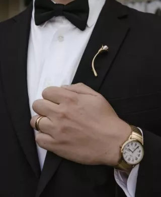Close up of brooch on lapel of tuxedo