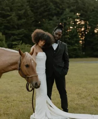 Models pose with a light brown horse on the grounds of Wind Mountain Ranch