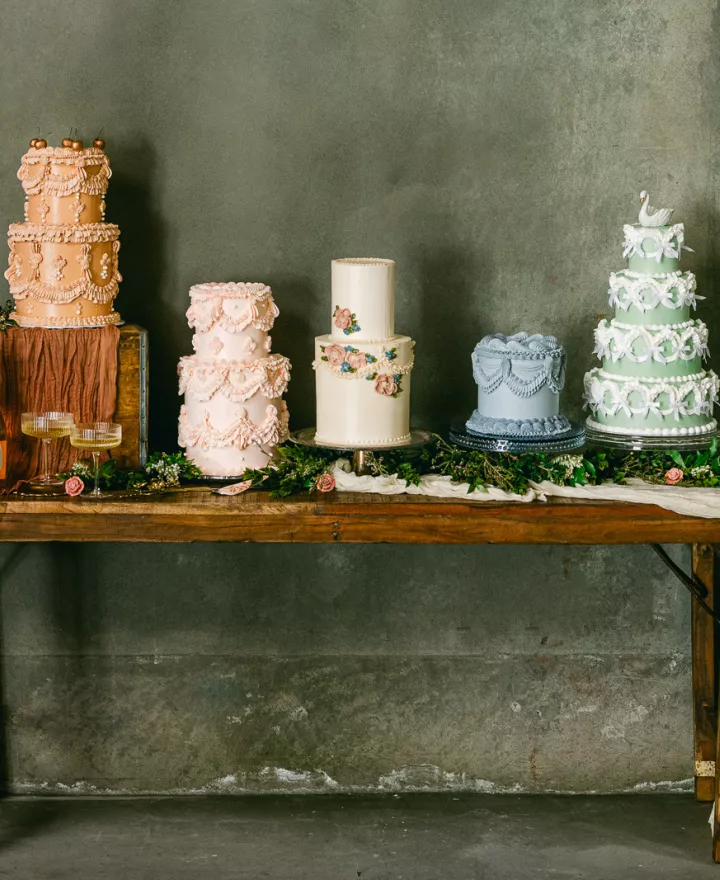 Five different vintage-style Lambeth cakes at wedding cake shoot with delicate details