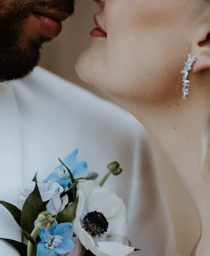 Models share a kiss in styled shoot close up shot