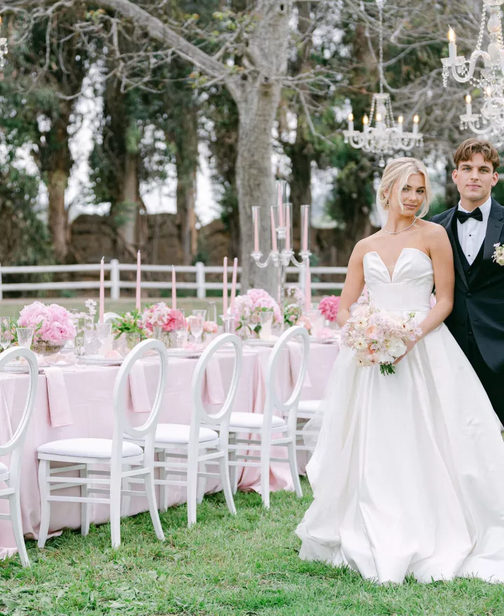 Model bride and groom in classic, chic wedding attire with blush, elegant reception table at Walnut Grove styled shoot