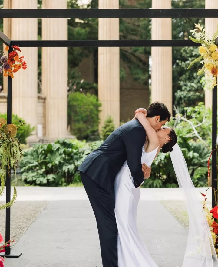 Bright colored florals decorate ecclectic wedding held under the roman rotunda at the Palace of Fine Arts