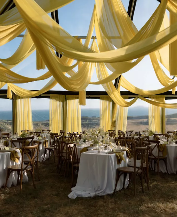 Bold chartreuse draping frames modern outdoor reception dinner at The Sea Ranch Lodge
