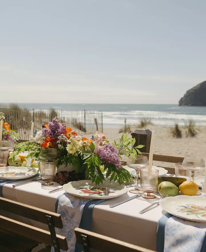 Minimal beach reception scene with bright florals and fruit accents at Pelican Brewing