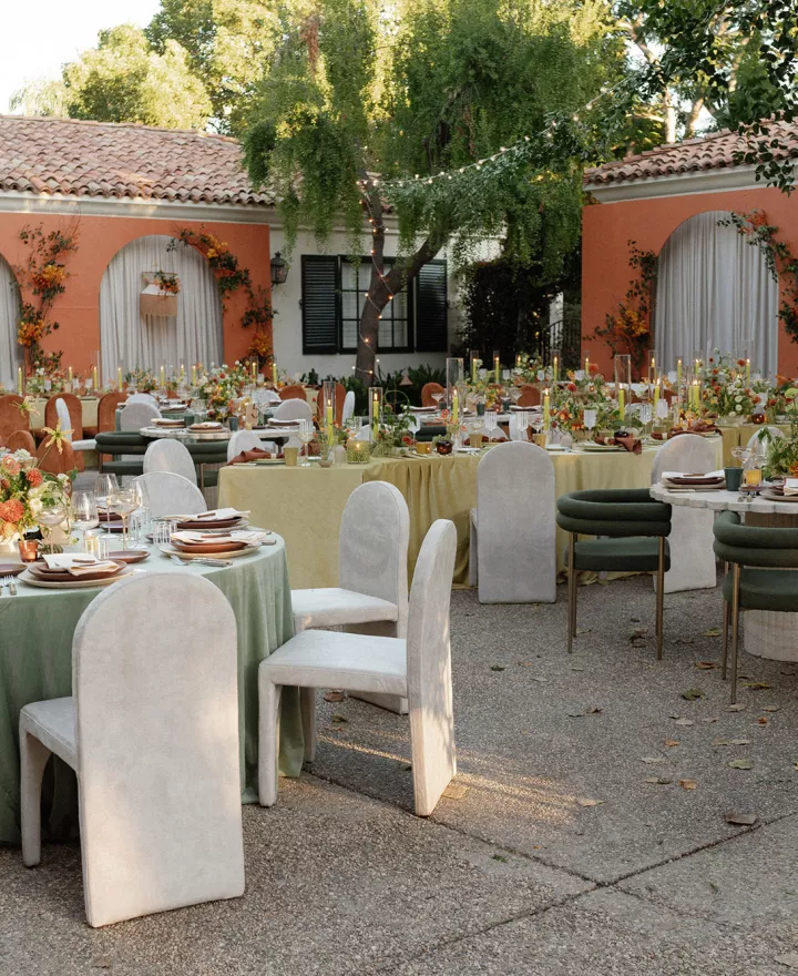 Mid-Century Modern reception scene featuring bold orange hues and serpentine table structures