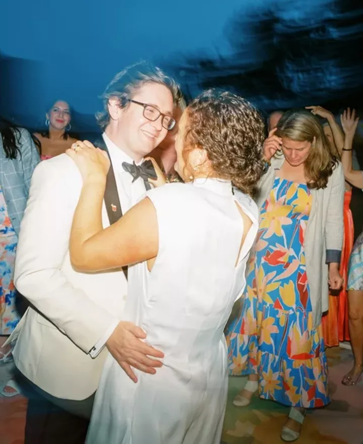 Bride and groom embrace on the dancefloor of their wedding day at the Admiral's House