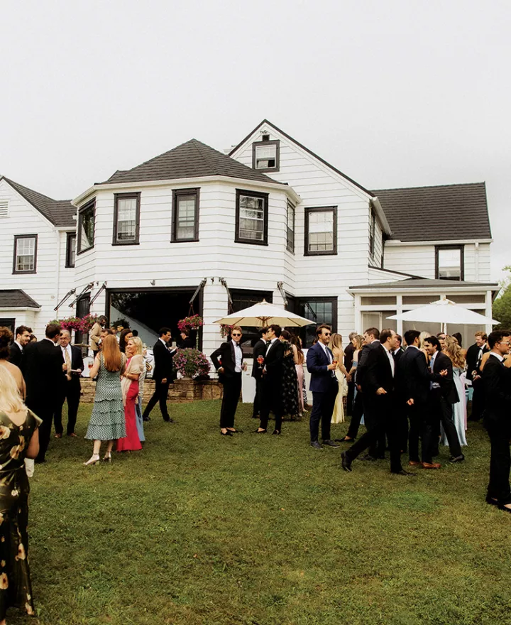 Lively cocktail hour unfolds on the back lawn of the Island Estate on Madeline Island