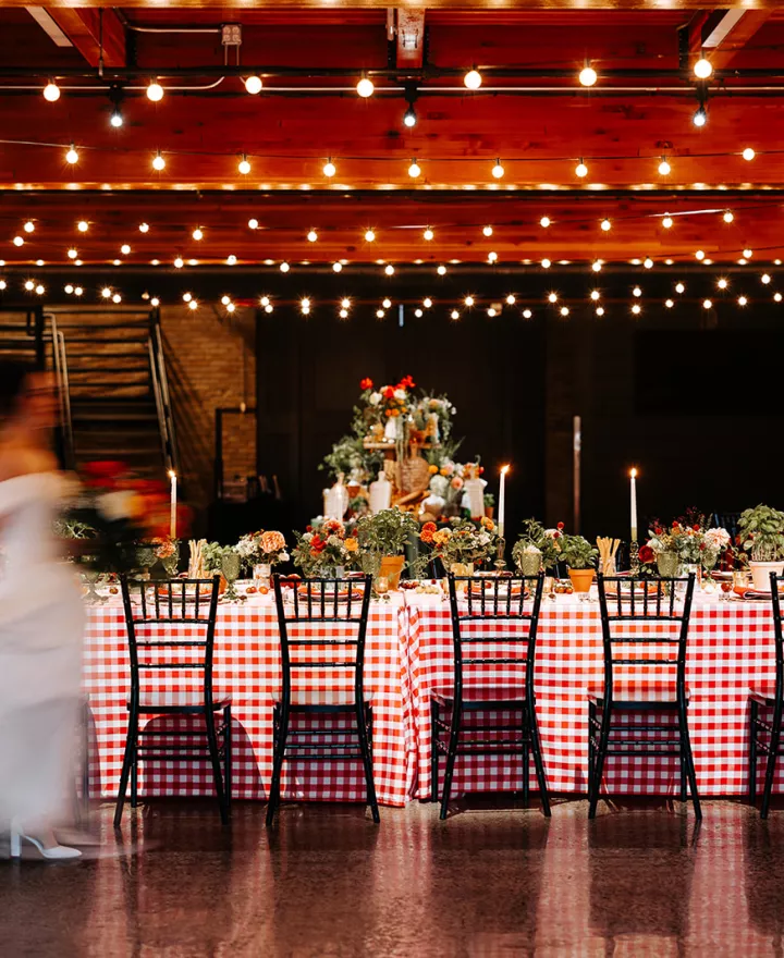 Cozy Italian restaurant-inspired reception featuring candlelight and produce infused tablescape at Essence Event Center