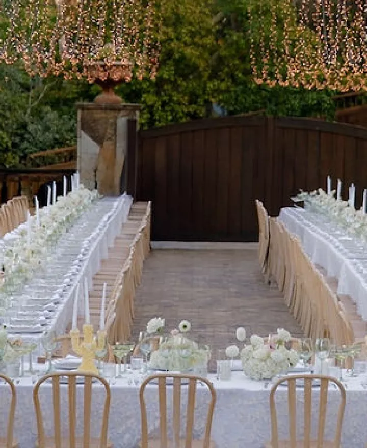 Outdoor reception scene with simple white décor at Private Residence