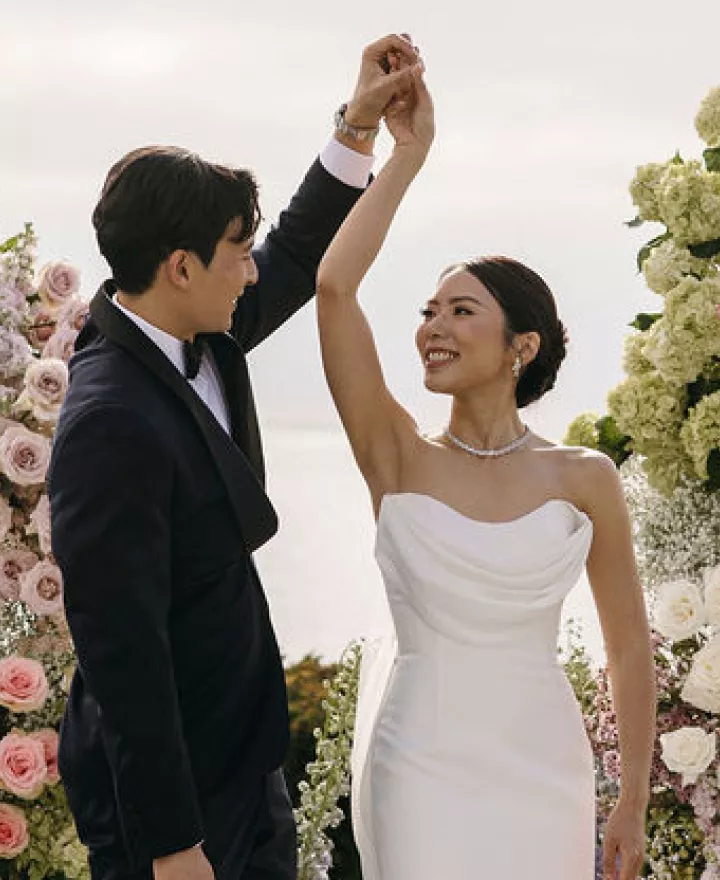 Groom spins bride on lush altarspace platform on their wedding day at Montage Laguna Beach