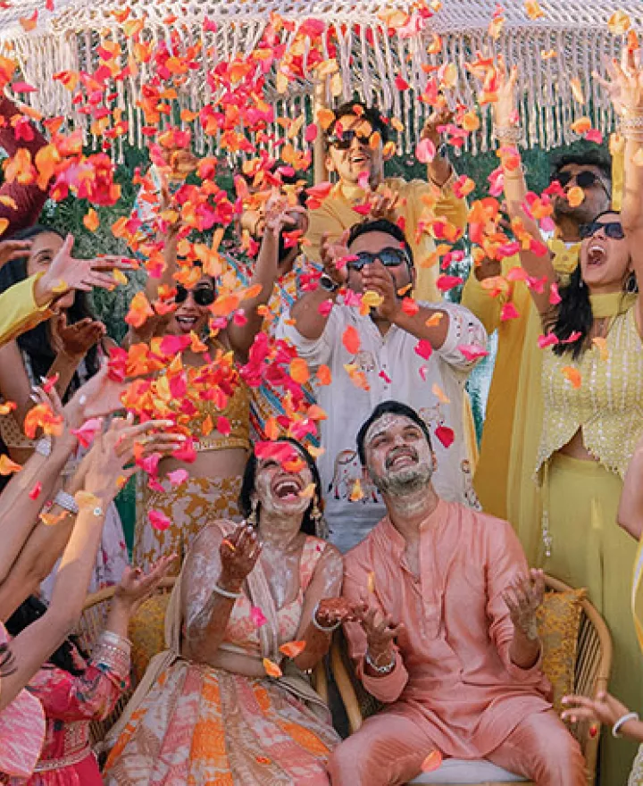 Bride and groom are showered in rose petals in celebratory opening evening for wedding weekend at Grand Hyatt Scottsdale REsort