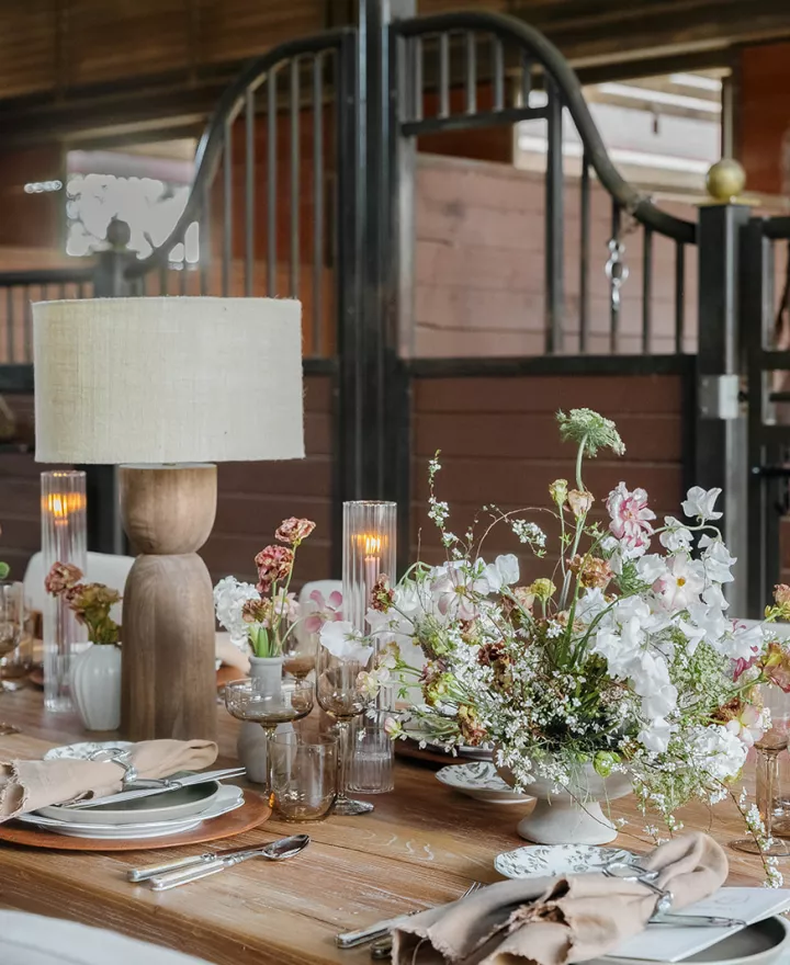 Earthy tablescape in the midst of a horse barn at TERI campus of life