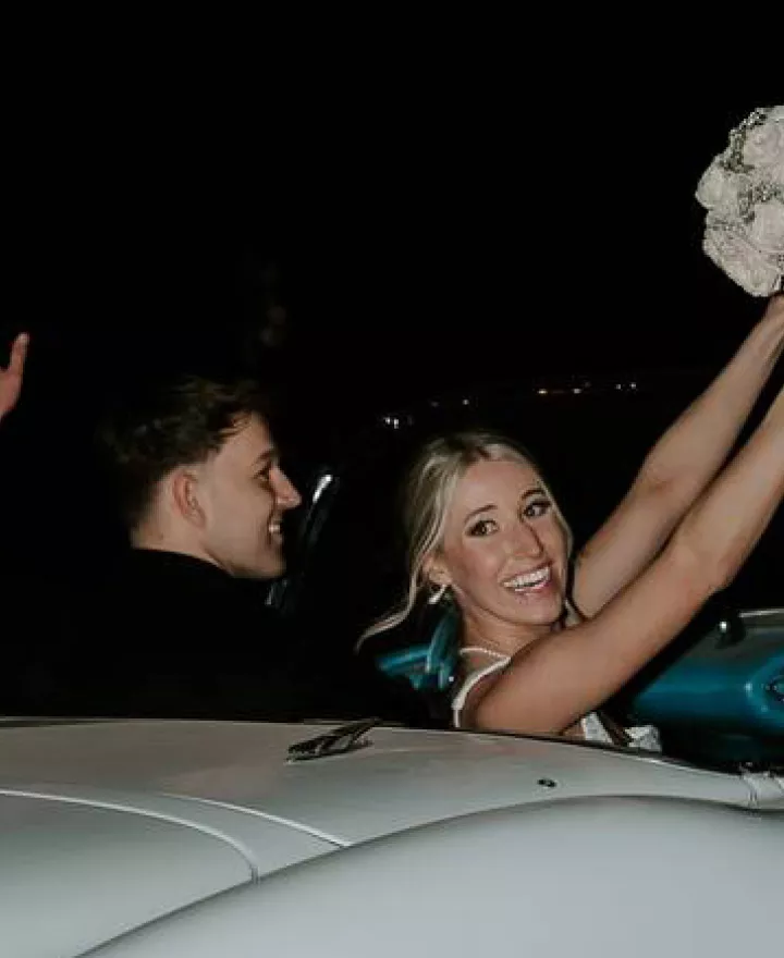 Madison and Sam in their vintage getaway car