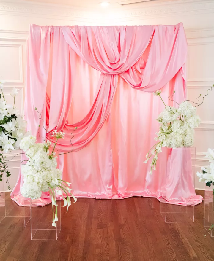 Pink satin kitschy ceremony backdrop at St. Paul College Club