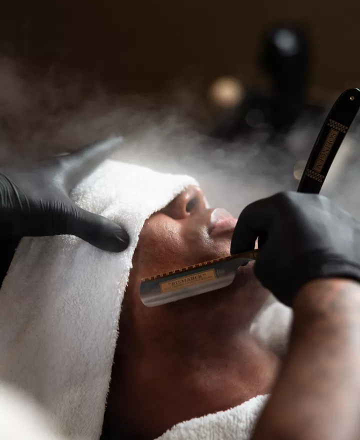 Man receiving groom barbershop pampering from JD Barba