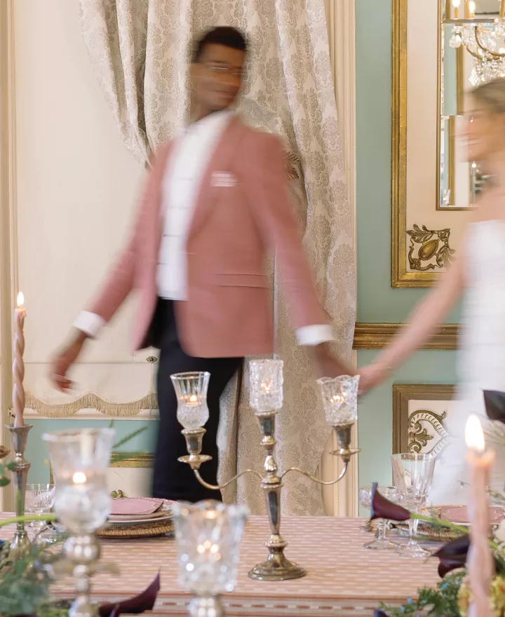 Models walk hand in hand amidst Ralph Lauren-inspired reception scene at Maxwell Mansion