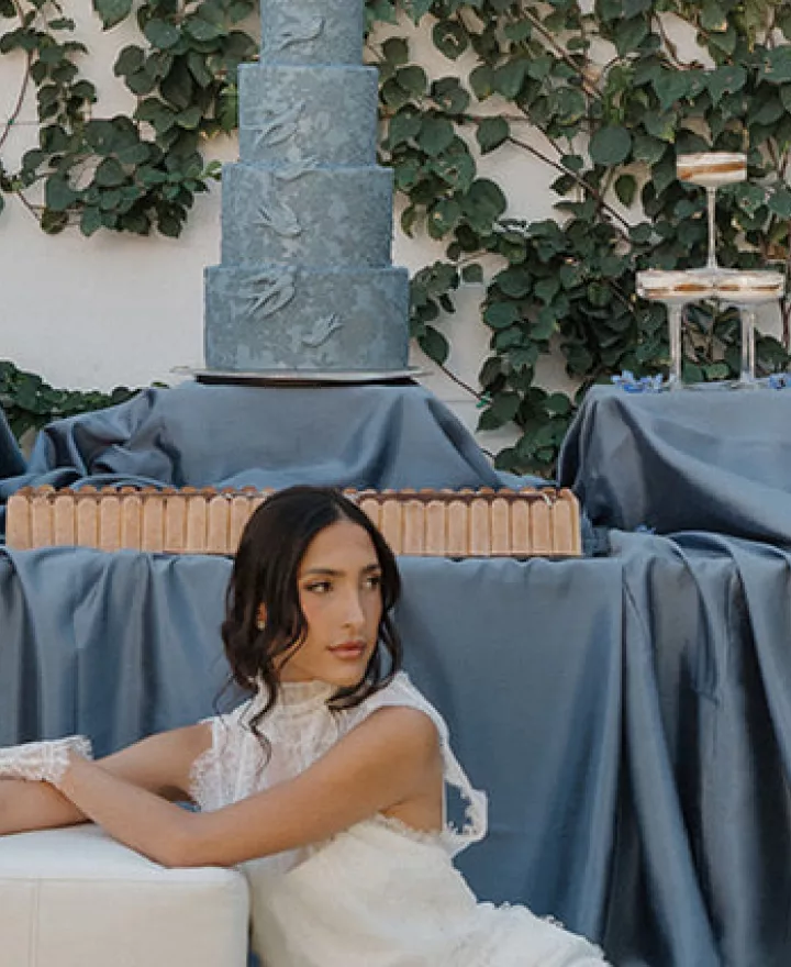 Model poses in front of a dessert table